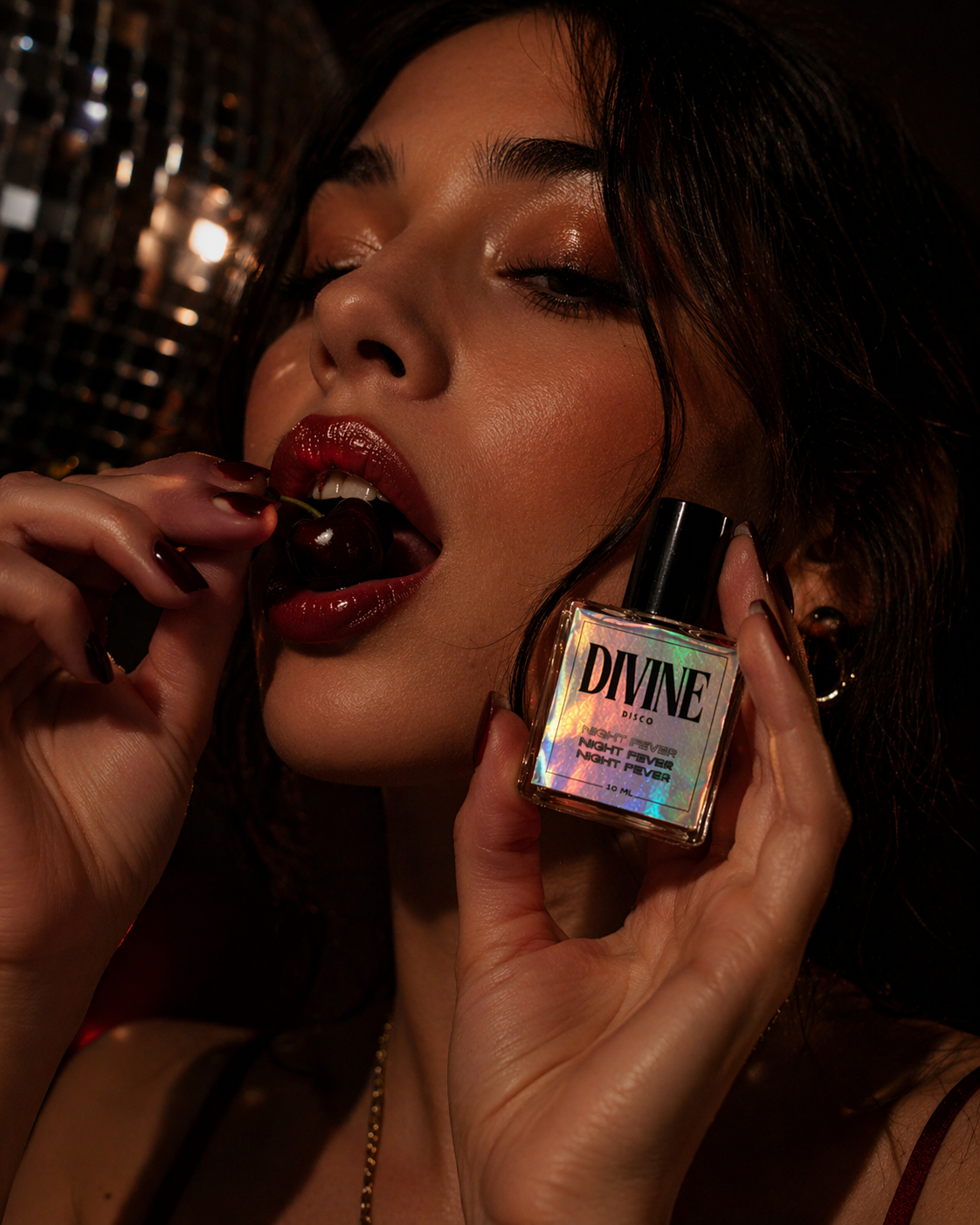 Woman eating a cherrywith a 'DIVINE Disco' product in the foreground